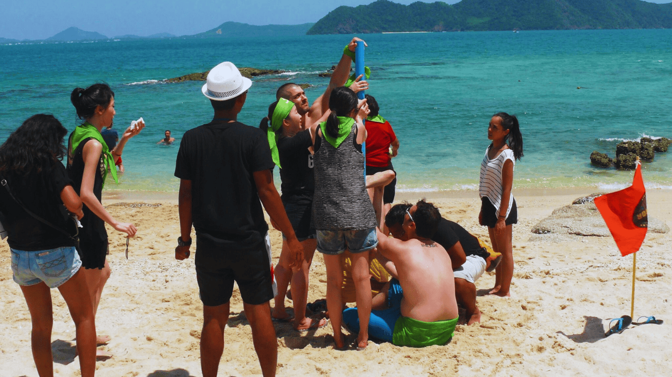 Team challenges and group obstacle courses on the beach bring people together