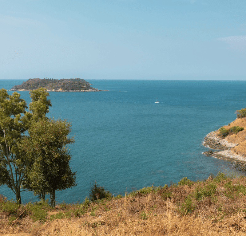 Spectacular vista from the promthep cape viewpoint, offering a panoramic scene of the majestic coastline, azure waters, and captivating natural beauty of the area. This phuket view point is a must see.