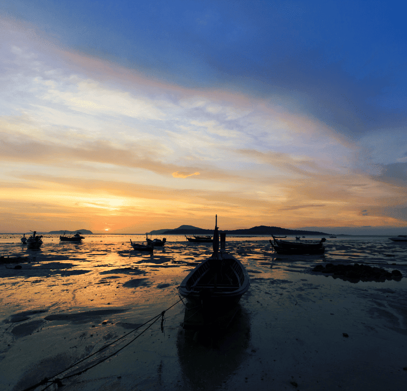 Sunrise phuket at rawai beach at low tide.